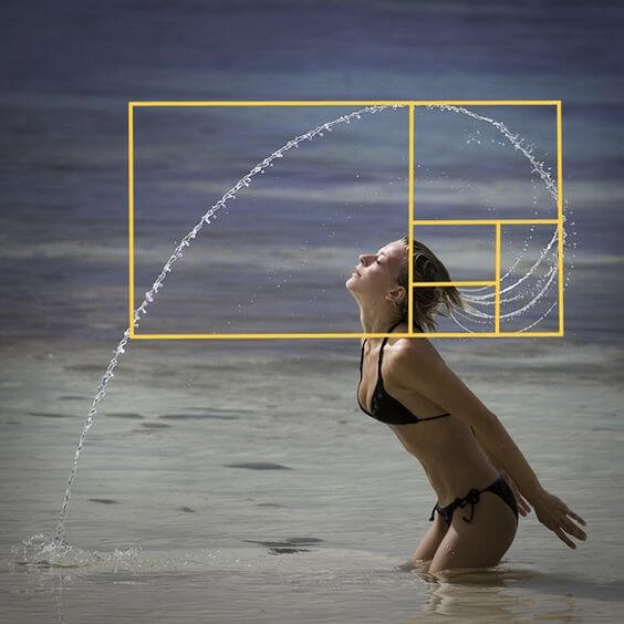 Girl at beach swinging water from her hair